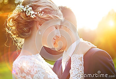 Young wedding couple on summer meadow Stock Photo