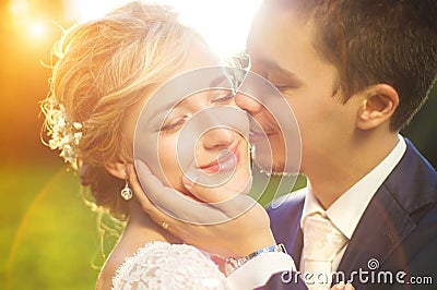 Young wedding couple on summer meadow Stock Photo