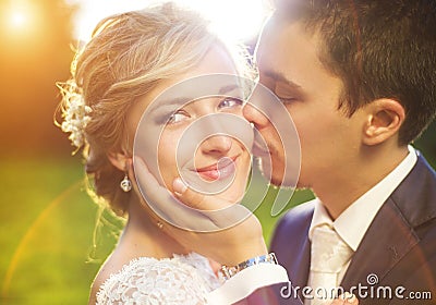 Young wedding couple on summer meadow Stock Photo