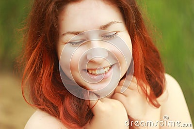 A young white Caucasian woman joyfully smiles and laughs with cute dimples on her cheeks. Stock Photo