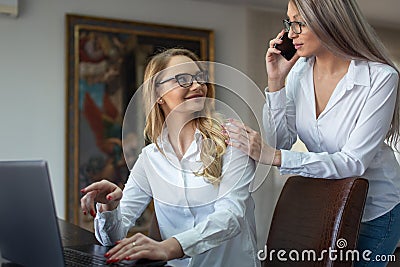 Young white collar lesbian businesswomen couple making business online Stock Photo