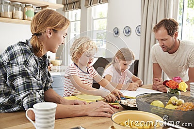 Young white family busy together in their kitchen, close up Stock Photo