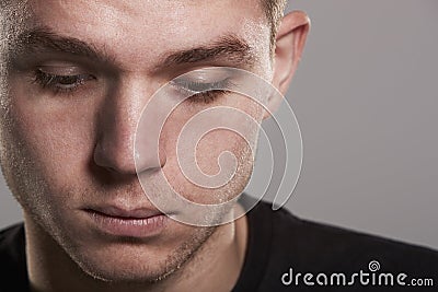 Young white man looking down, close up Stock Photo