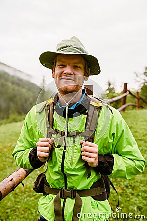 Young man wearing trekking equipment hiking in mountain forest Stock Photo