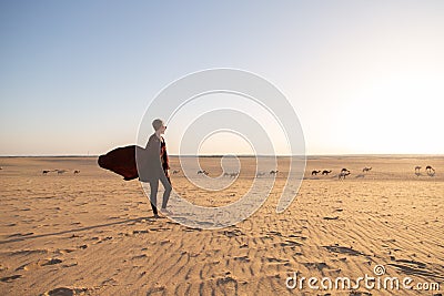 Young woman with abaya in the Salisil desert in Saudi Arabia Stock Photo