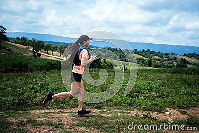 Young women active trail runners the top of a mountain in the afternoon, ultra marathon runners adventuring outdoors Stock Photo