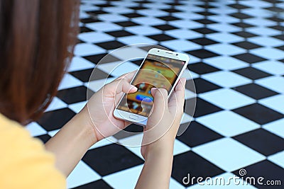 Young woman activities playing video games on smartphone, education and Internet of Things IoT Stock Photo