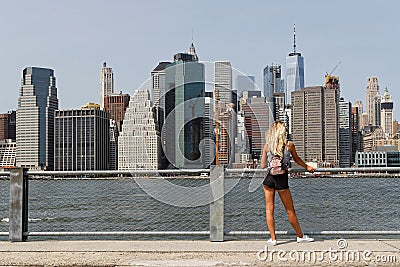 A young woman admires the view of Manhattan skyline Editorial Stock Photo