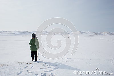 Young woman adventuring in a frozen lanscape Stock Photo