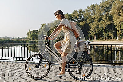 Young woman against nature background with bike Stock Photo