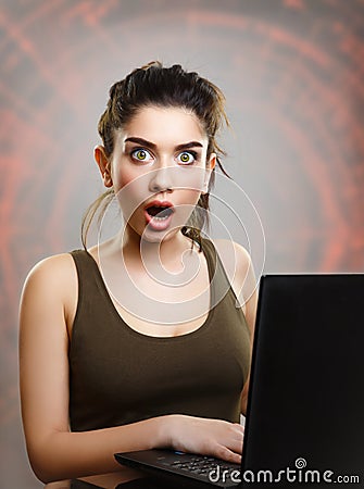 Young woman amazed and shocked by internet news Stock Photo