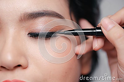 Young woman applied eyeliner close-up Stock Photo