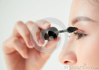 young woman applied mascara to her lashes Stock Photo