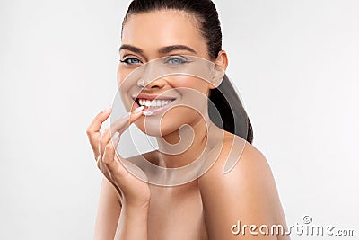 Young woman applying cosmetics cream on lips for skin care and hydration using balm moisturizer Stock Photo