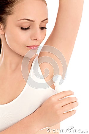 Young woman applying deodorant Stock Photo
