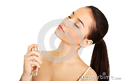 Young woman applying parfume. Stock Photo