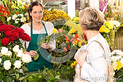 Young woman arranging flowers shop market selling Stock Photo