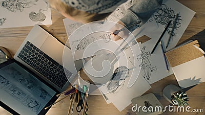 Young woman artist draws pencil sketches works on storyboard of a comic top view Stock Photo