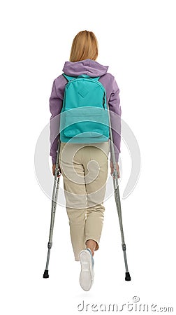 Young woman with axillary crutches on white background, back view Stock Photo