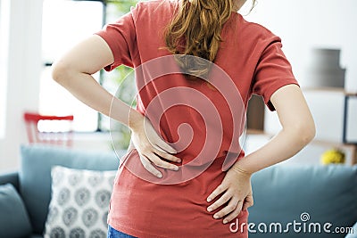 Young woman with back pain Stock Photo