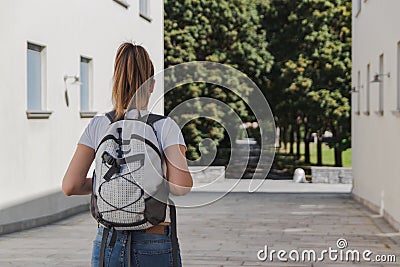 Young woman with backpack walking to school after summer holidays Stock Photo