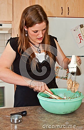 Young Woman Baking Cookies with Mixer Stock Photo