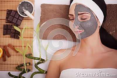 Young woman in beauty salon having face mask Stock Photo