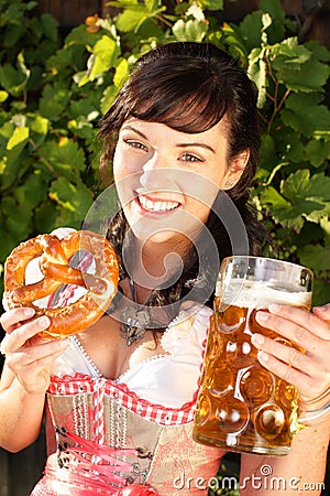 Young woman with beer glasses and bretzel Stock Photo