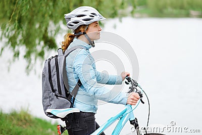 Young woman with bicycle. Beautiful woman walking in the park Stock Photo