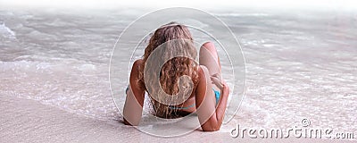 Woman laying by tropical sea Stock Photo