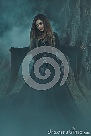 A young woman in black robe with long hair looking directly at c Stock Photo