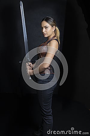 Young woman in urban fantasy poses on a black background Stock Photo