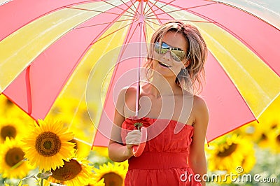 Young woman on blooming sunflower field Stock Photo