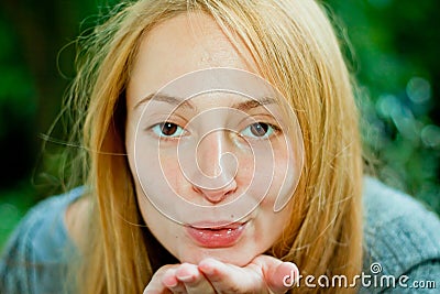 Young woman blowing an air-kiss Stock Photo