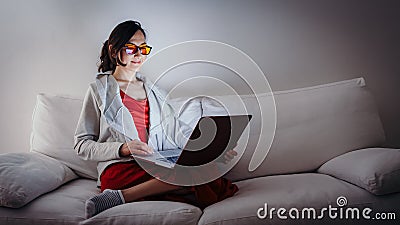 Young woman with blue light blocking glasses yellow lenses Stock Photo