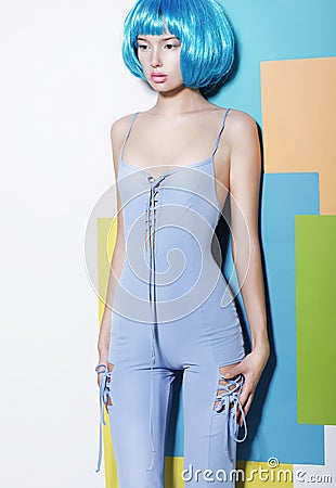 Young Woman in Blue Overalls and Creative Wig Stock Photo