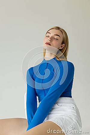 young woman in blue zipped turtleneck Stock Photo