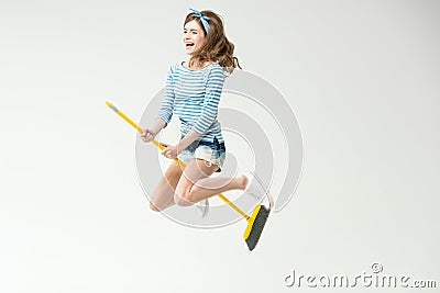 Young woman with broom Stock Photo