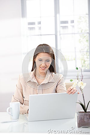 Young woman browsing internet at home Stock Photo