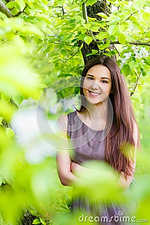 Young woman the brunette in the spring blossoming garden Stock Photo