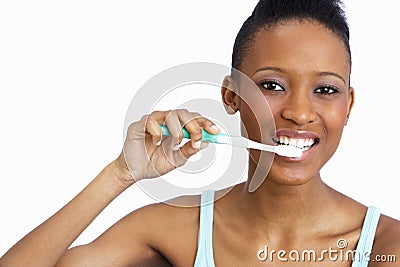 Young Woman Brushing Teeth In Studio Stock Photo