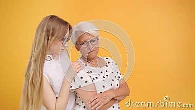 Young woman calming down senior lady after bad news. Family love and care concept Stock Photo