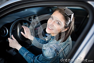 Young woman in car going on road trip.Learner driver student driving car.Driver license exam Stock Photo