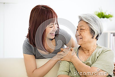 Young woman carefully takes care of old woman Stock Photo