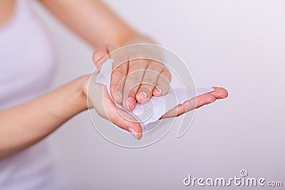 Woman carefuly cleaning hands with wet wipes Stock Photo