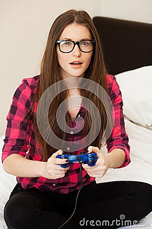 Young woman in casual playing videogame Stock Photo