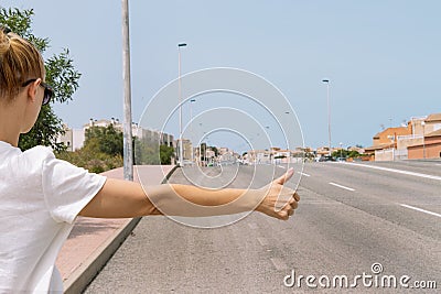 A young woman catches a car on the road close-up on her hand, automatic stop, automatic braking Stock Photo