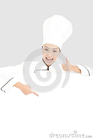 Young woman chef smiling and thumb up with blank board Stock Photo