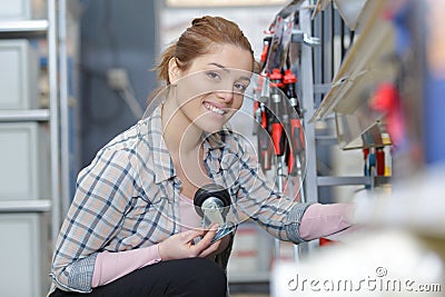 young woman choosing items hardware shopping Stock Photo