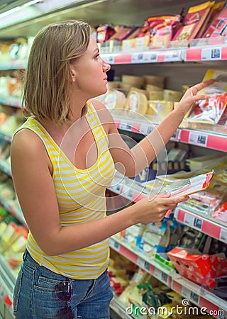 Young woman choosing meat. Stock Photo